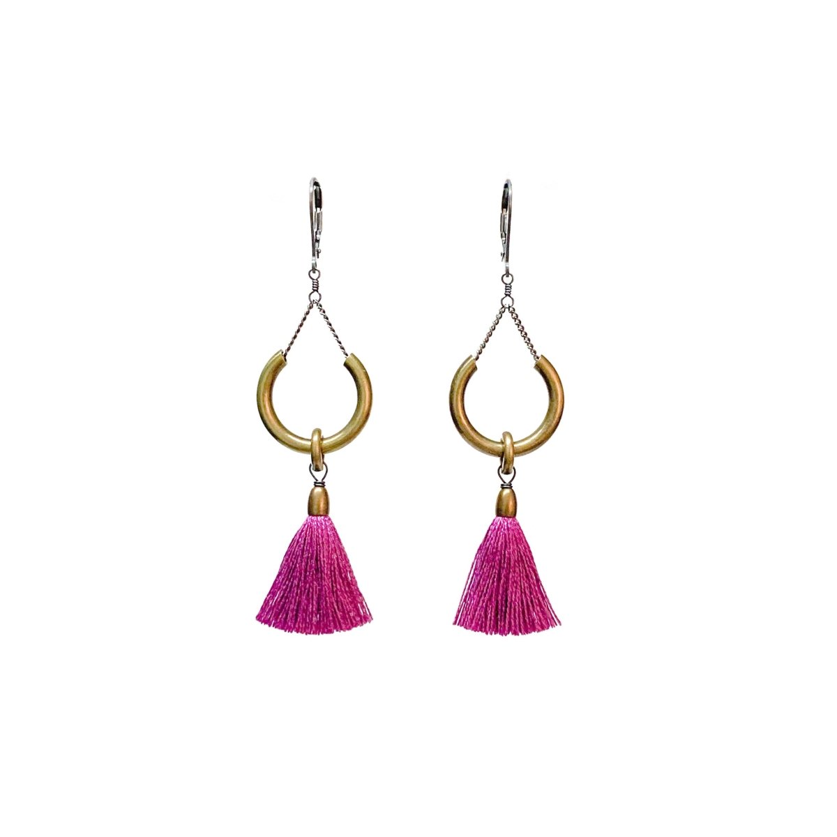 A pair of earrings with silver clasps, a brass ring and fuchsia tassels. The Duster Earrings in Hot Violet are from Portland designer Emily Bixler of BOET.