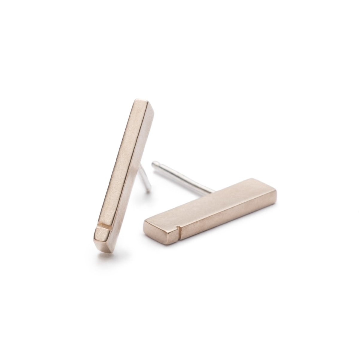 Slim, rectangular bronze bars with a notch detail at one end, soldered to sterling silver earring posts. Hand-crafted in Portland, Oregon.