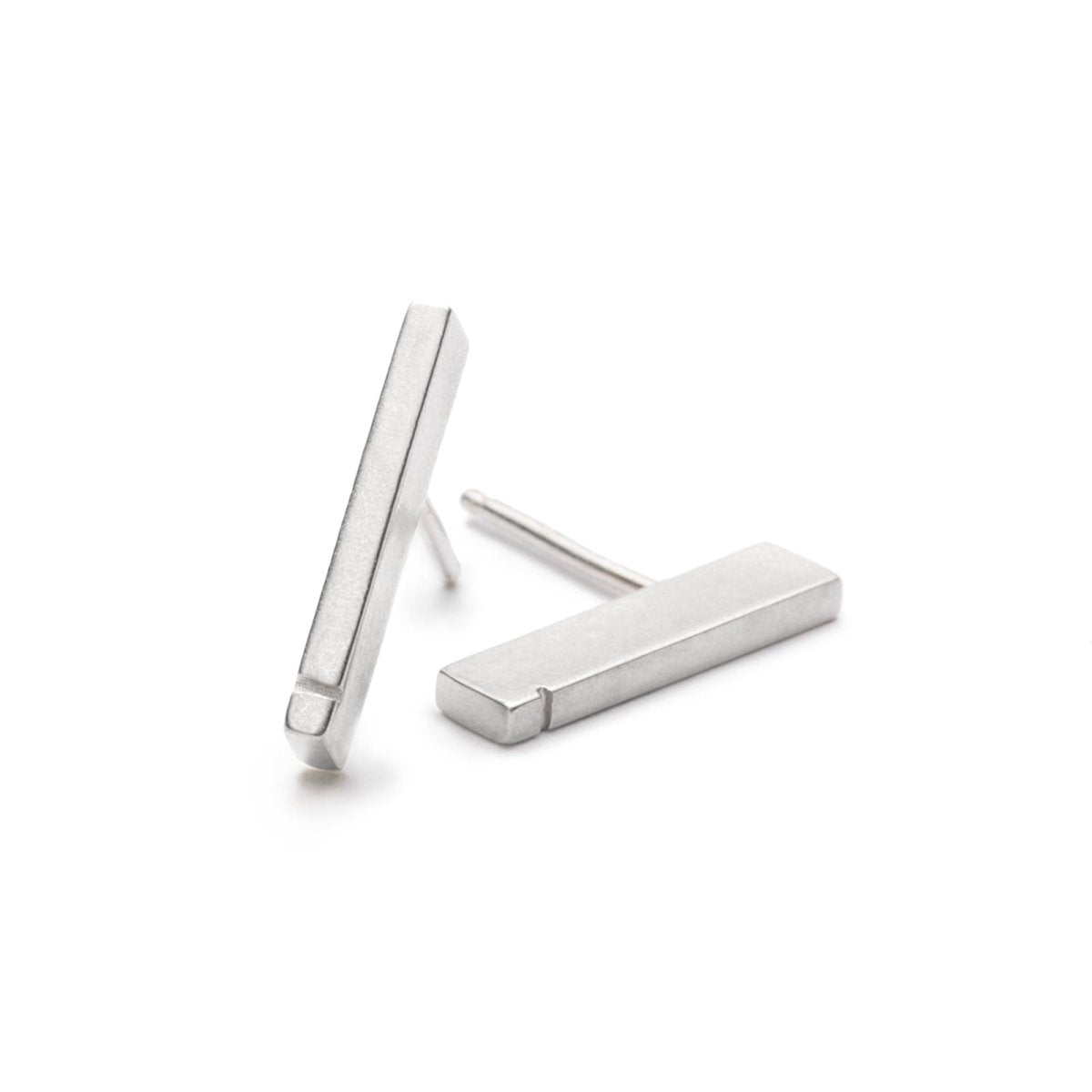 Slim, rectangular sterling silver bars with a notch detail at one end, soldered to sterling silver earring posts. Hand-crafted in Portland, Oregon.
