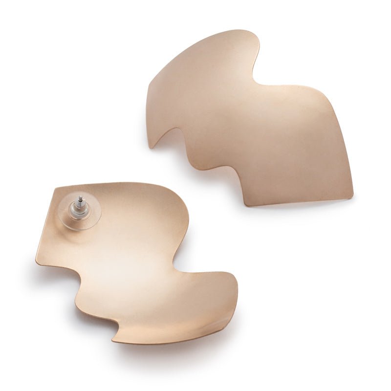 A pair of large, eye-catching, bronze shields with wavy edges, affixed to sterling silver earring posts, and finished with sterling silver and plastic comfort earring backs. Hand-crafted in Portland, Oregon.