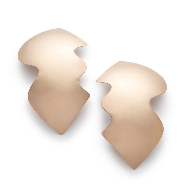 A pair of large, eye-catching, bronze shields with wavy edges, affixed to sterling silver earring posts. Hand-crafted in Portland, Oregon.