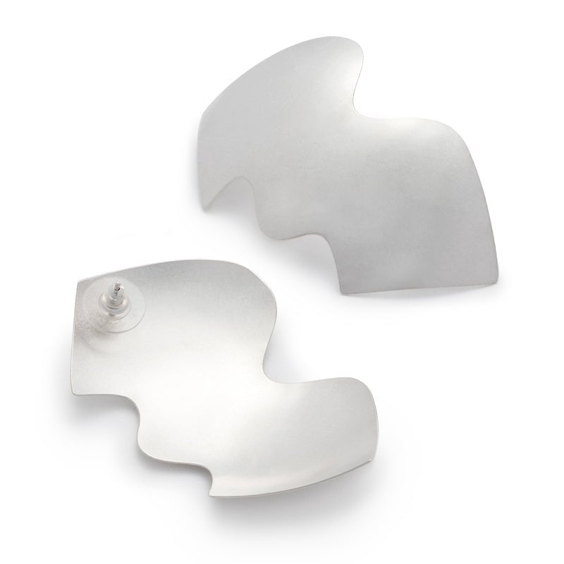 A pair of large, eye-catching, sterling silver shields with wavy edges, affixed to sterling silver earring posts, and finished with sterling silver and plastic comfort earring backs. Hand-crafted in Portland, Oregon.