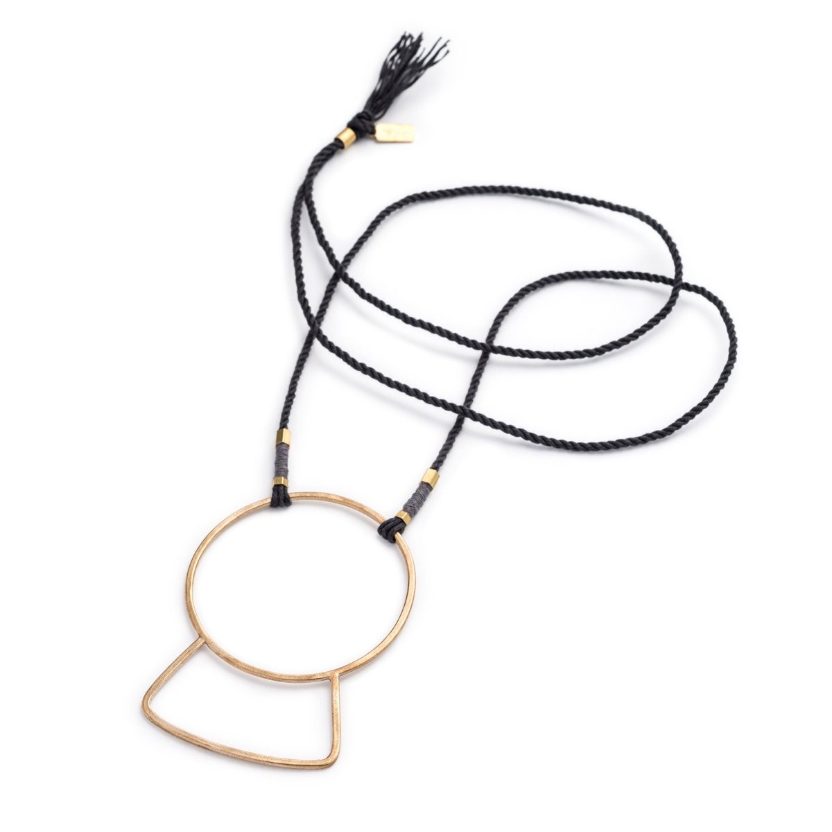 Long necklace of gray, hand-spun Japanese cotton thread, featuring a large, geometric, yellow bronze focal piece, brass tubing, small copper wire accents, and a brass betsy & iya tag. Hand-crafted in Portland, Oregon.