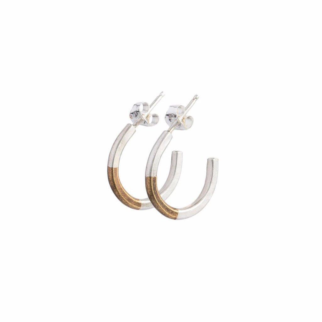 Minimalist and lightweight miniature hoop earrings of mixed brass and sterling silver hand-forged wire, with soldered sterling silver earring posts and sterling silver butterfly backings. Hand-crafted in Portland, Oregon.