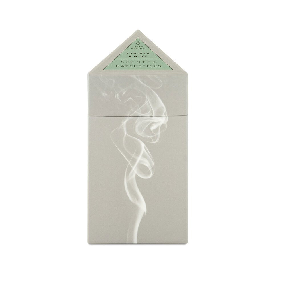 Triangular box holding matches against a white background. The box is grey with a picture of white smoke. The Prism Scented matches are from designer Skeem and made in the USA.