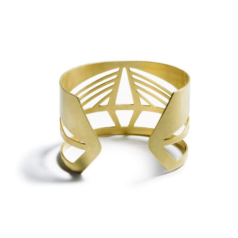 Bold, modern, and adjustable brass cuff bracelet modeled after the Ravenel Bridge in South Carolina, with the bridge's year of construction and geographic coordinates etched on the inner cuff. Hand-crafted in Portland, Oregon.
