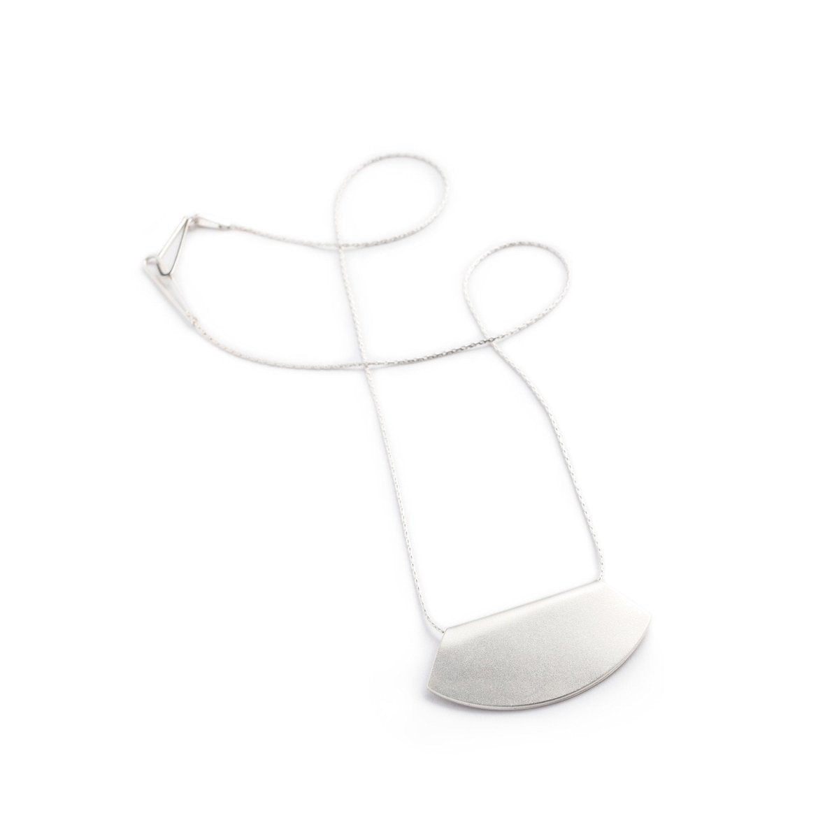 Delicate, 18 inch long sterling silver chain threaded through a fan-shaped silver-plated pendant, engraved on one side with the betsy & iya logo. Hand-crafted in Portland, Oregon.