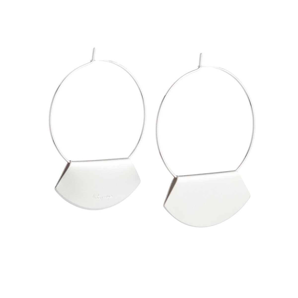 Hand-formed hoop earrings of sterling silver wire, with folded, fan-shaped, silver-plated pendants, engraved with the betsy & iya logo. Hand-crafted in Portland, Oregon.