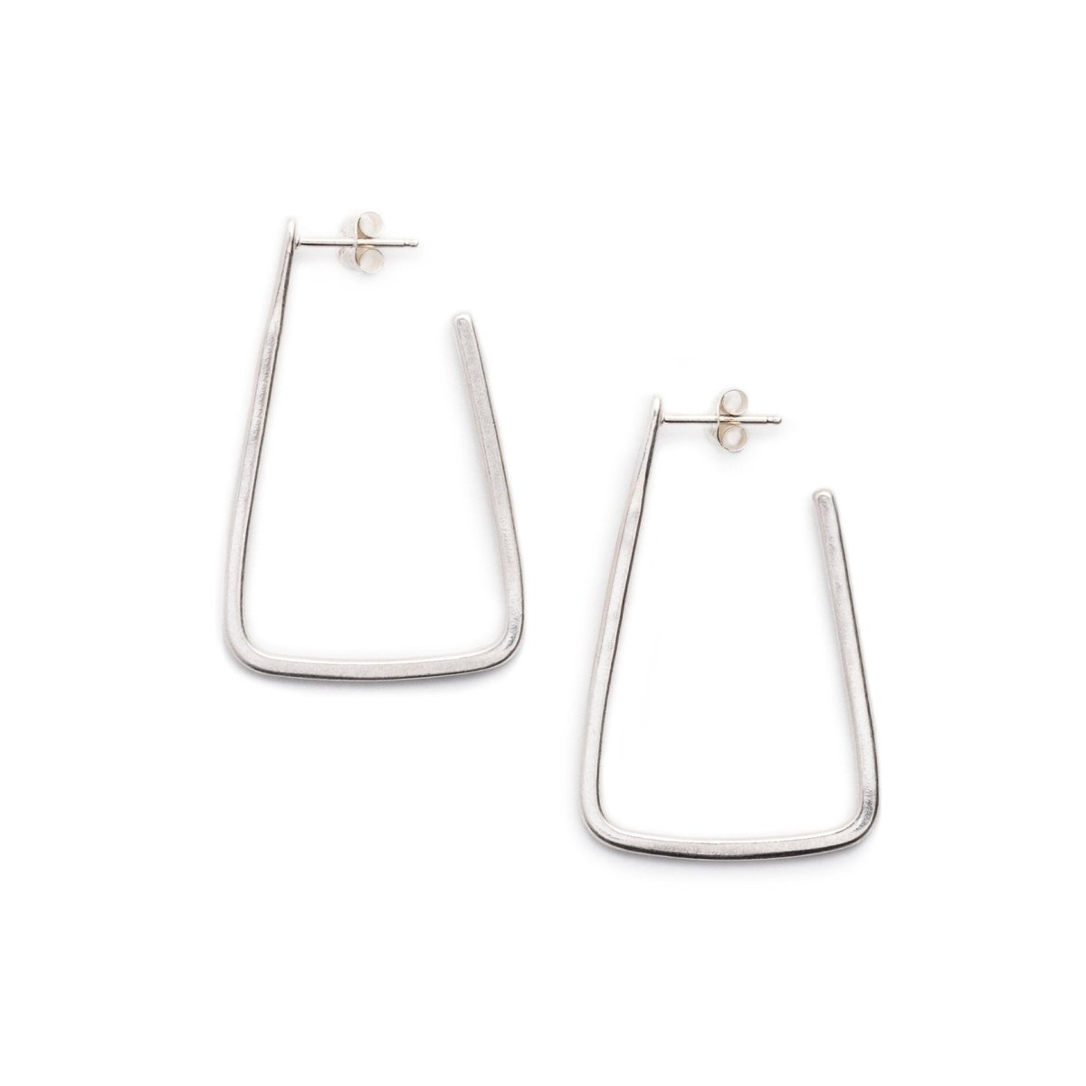 Simple, geometric, silver hoop earrings with curved edges and a matte finish, sterling silver earrings posts, and sterling silver butterfly earring backings. Hand-crafted in Portland, Oregon.