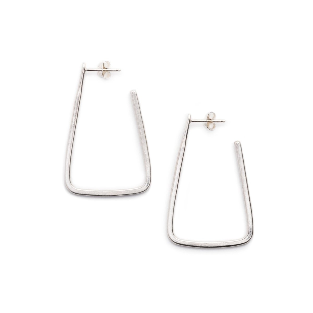 Simple, geometric, silver hoop earrings with curved edges and a matte finish, sterling silver earrings posts, and sterling silver butterfly earring backings. Hand-crafted in Portland, Oregon. 