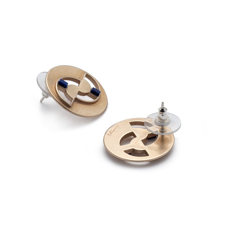 Circular, quarter-sized bronze studs with cutouts, ethically sourced, fair trade lapis lazuli inlays, sterling silver earring posts, and sterling silver and plastic comfort-clutch backings. Hand-crafted in Portland, Oregon.