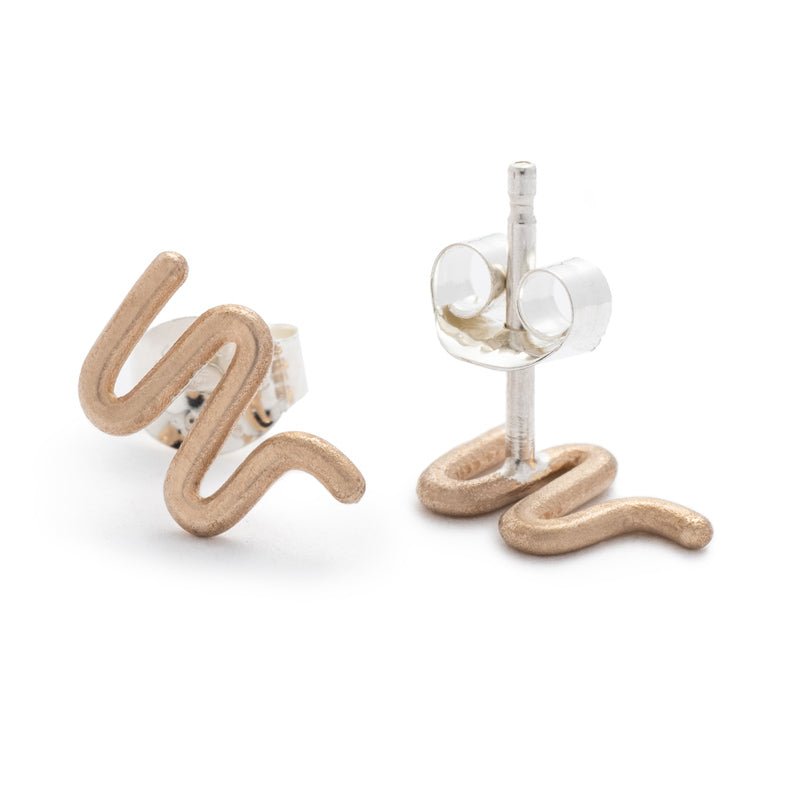 Tiny, bronze, snake-inspired studs with sterling silver earring posts and ear nuts. Hand-crafted in Portland, Oregon.