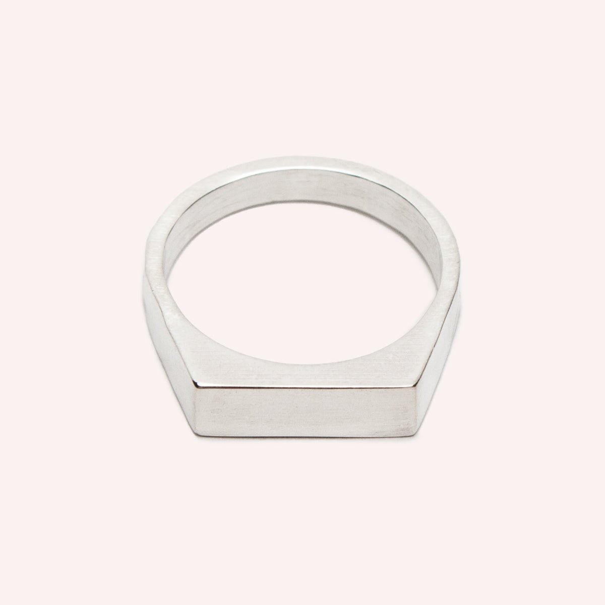  A narrow signet ring with a polished rectangular top and hammered detail on the band. Made in solid sterling silver. Designed and handcrafted in Portland, Oregon.