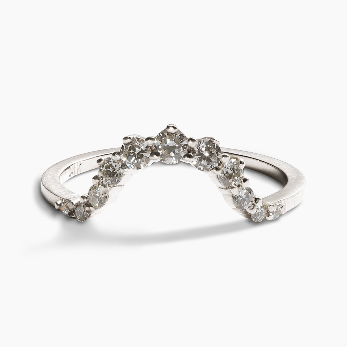 Arched Ortus ring, with prong set lab-grown diamonds. This contoured stacking band is made of 14K recycled white gold.