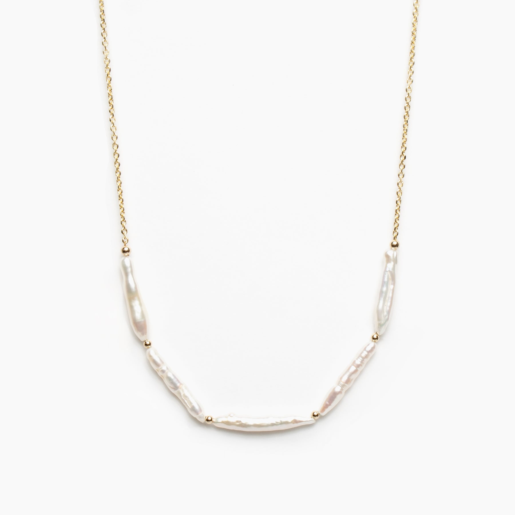 Gold necklace with five stick pearl beads on a white background