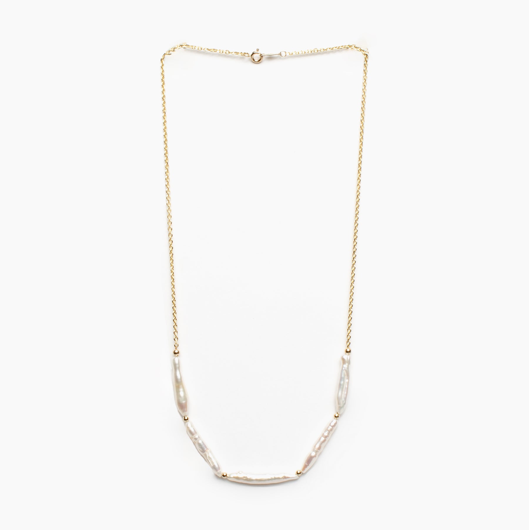 Gold necklace with pearl beads on a white background