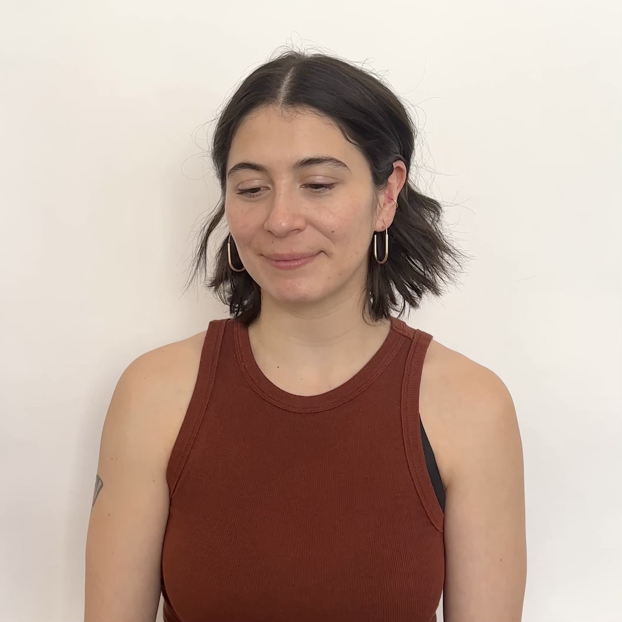 A model wears the small Vivida Hoop Earrings and turns their head slightly. designed and handcrafted in Porltand, oregon.