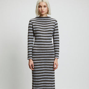 A long sleeve dark and light gray striped dress with a high neckline. The Alice Dress in Stripes is designed by Rita Row in Girona, Spain.