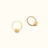 Petite circular brass stud ring, with a small bottom portion wrapped with peach colored glass beads. The Fei Stud earrings in Peach are designed by A Nod To Design and handmade in Portland, Oregon.