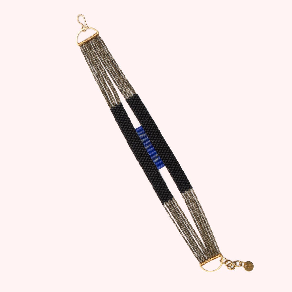 Ladder Bracelet made of black and lapis beds strung on antique brass chains. Handmade by A Nod To Design in Portland, OR.