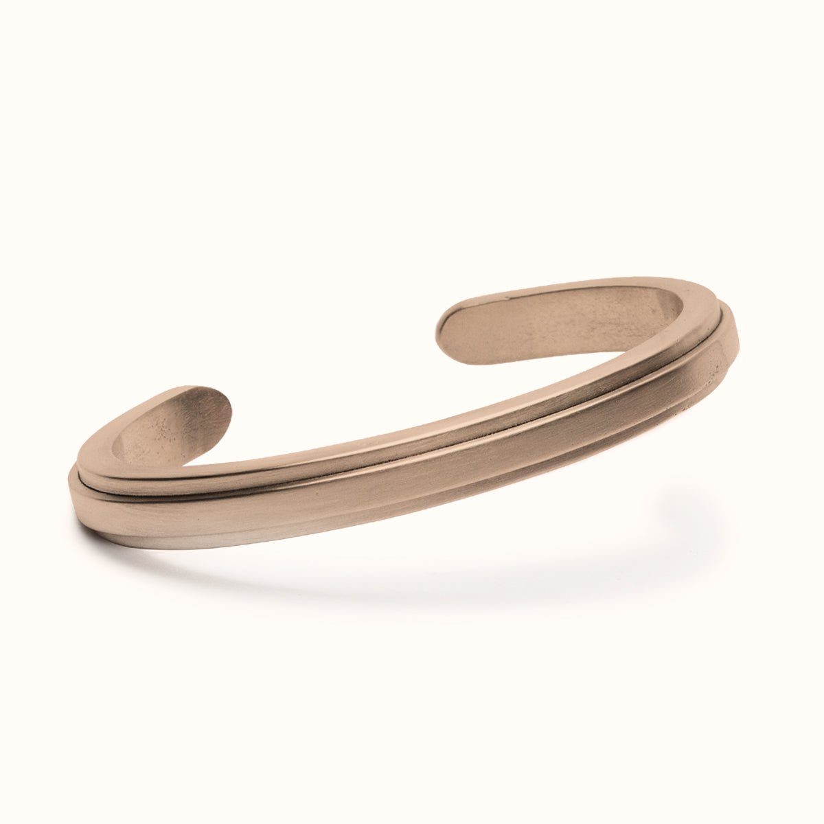 A squared off solid bronze cuff with an exterior band of bronze running down the center. The Amanca Cuff is designed and handcrafted in Portland, Oregon.