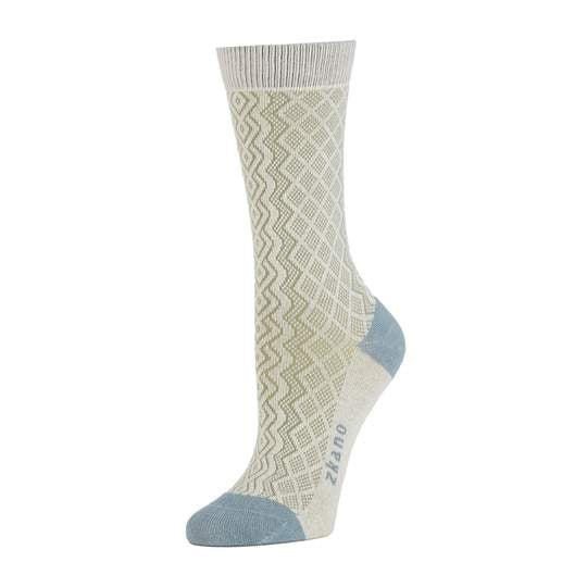 Light grey sock with light brown crisscrossed knitted pattern. Heel and toe of sock are a blue/grey as well as the logo along the arch. The Aran Knit Sock in Pearl is from Zkano and made in Alabama, USA.
