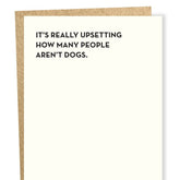 Black text on white greeting card reads: "IT'S REALLY UPSETTING HOW MANY PEOPLE AREN'T DOGS." Designed and made by Sapling Press in Pittsburgh, PA.