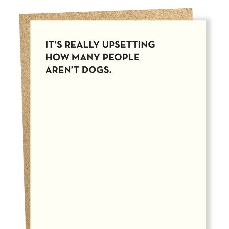 Black text on white greeting card reads: "IT'S REALLY UPSETTING HOW MANY PEOPLE AREN'T DOGS." Designed and made by Sapling Press in Pittsburgh, PA.