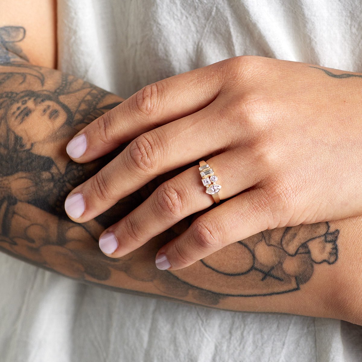 Model wears the Astrum ring on their left hand. The Astrum ring features 5 lab-grown diamonds and recycled 14K gold.