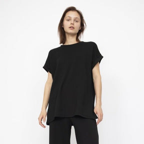 Flowy short sleeve tunic top in Black with a left side slit. Fabric and top made in Los Angeles, CA by Corinne Collection.
