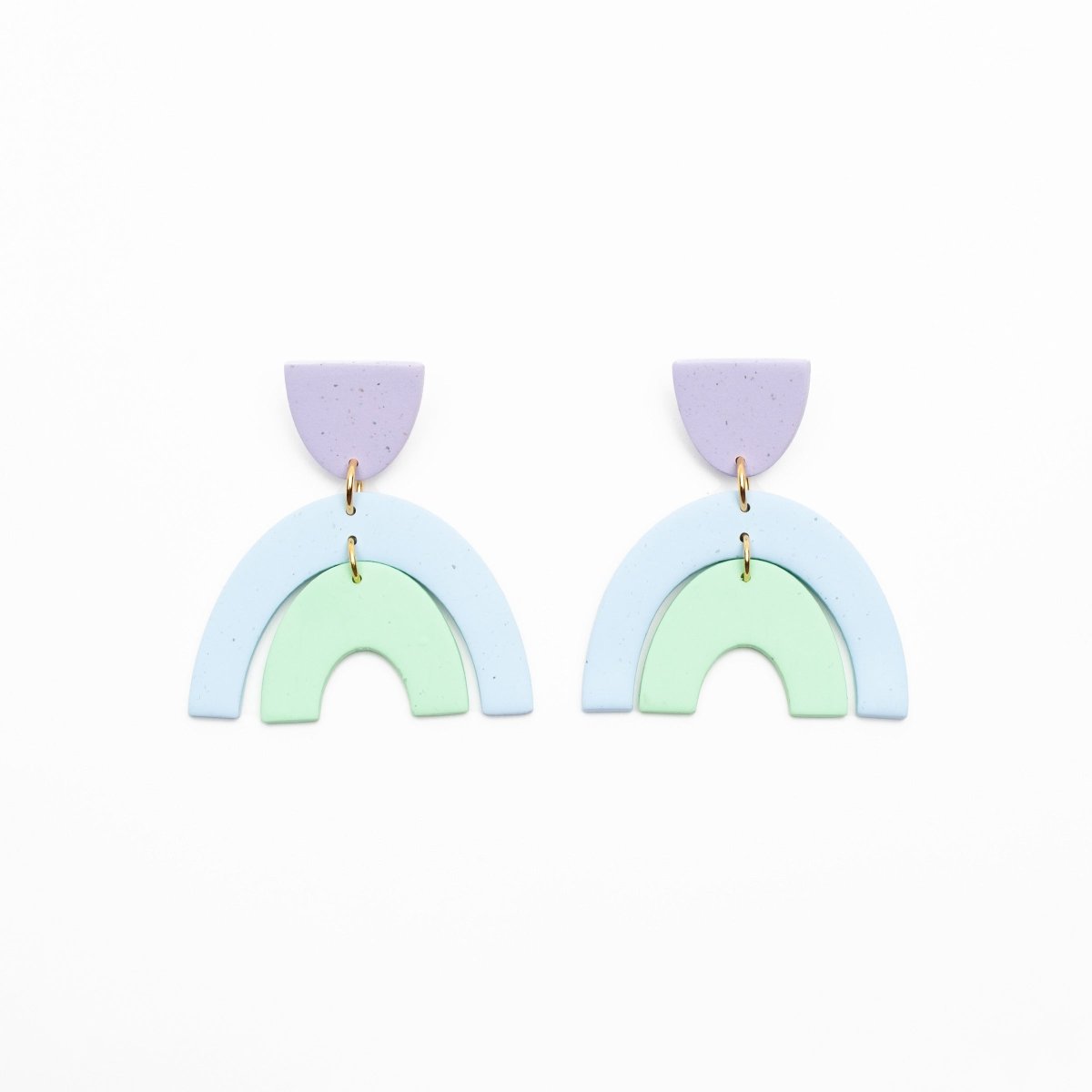 A pair of light purple, blue and green polymer clay earrings with a small half oval stud and two nestled arches connected by stainless steel. Designed and crafted in Portland, Oregon by The Baked Clay Studio.