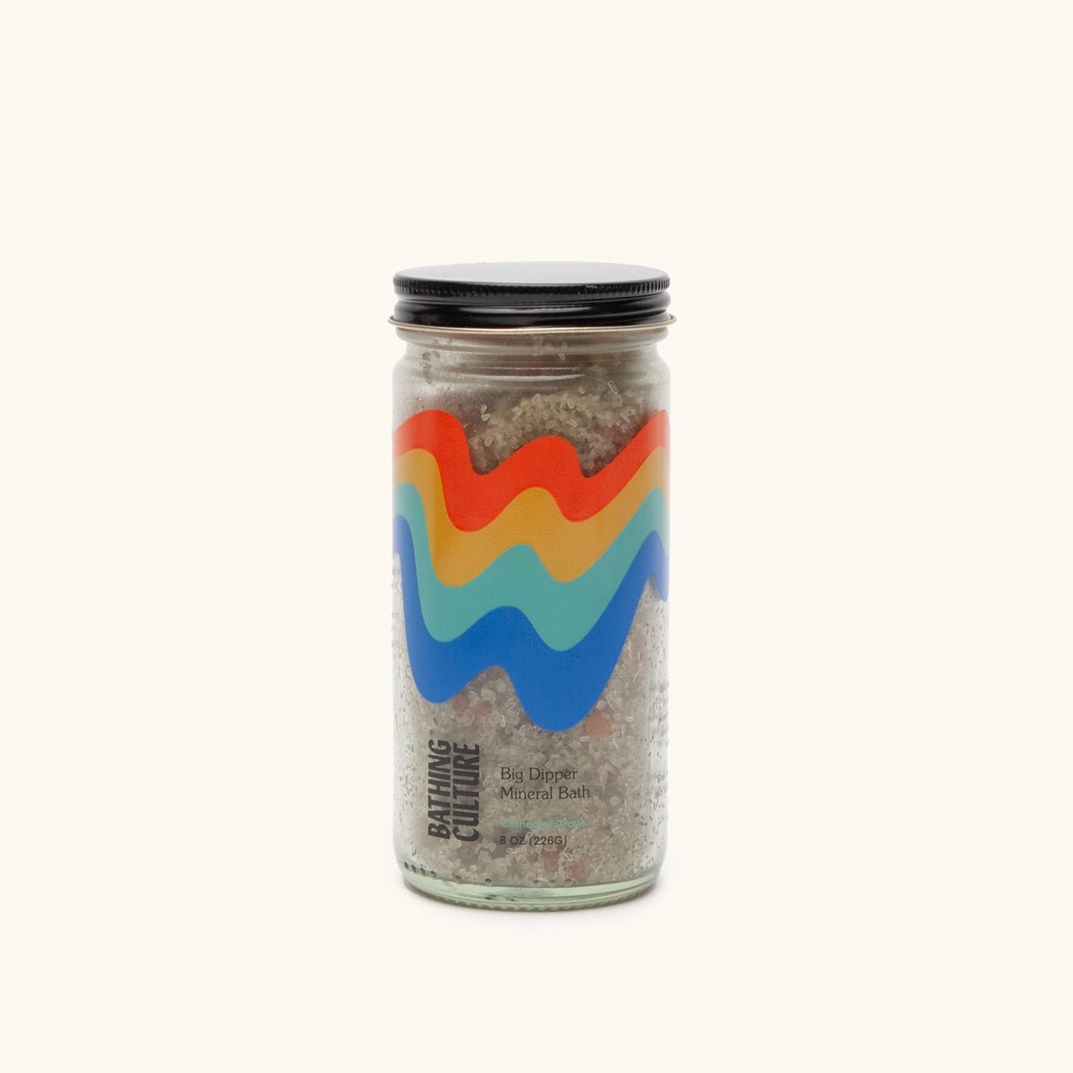 A clear glass jar holds a mineral bath soak. The Big Dipper Mineral Bath is handcrafted by Bathing Culture in San Francisco, California.