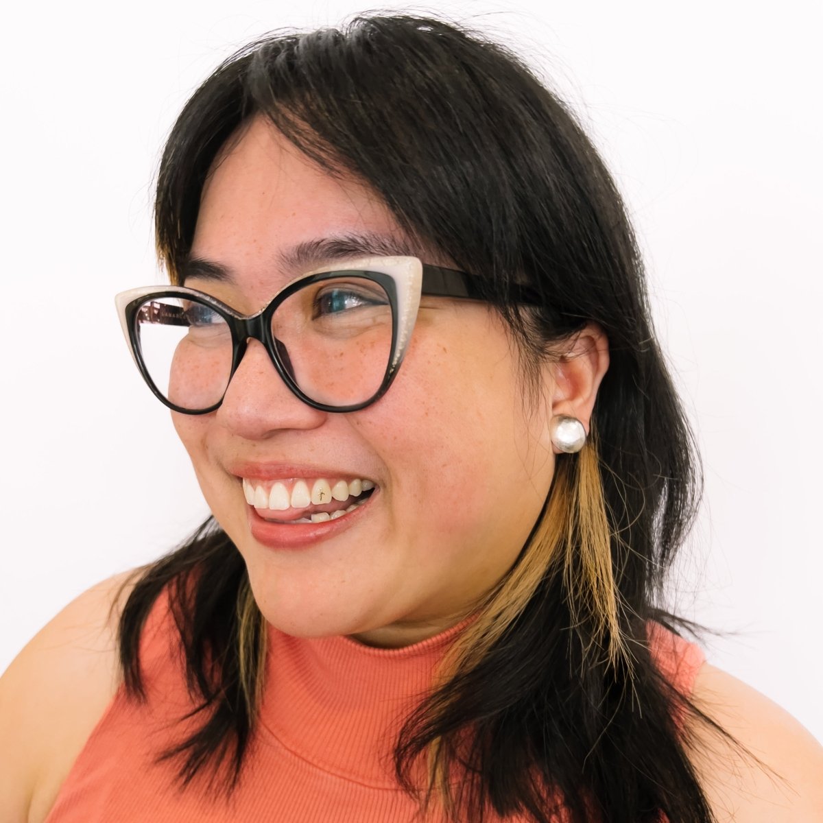 A model wears a circular and rounded hand hammered sterling silver stud earring. The Sentia Earrings are designed and handcrafted in Portland, Oregon.