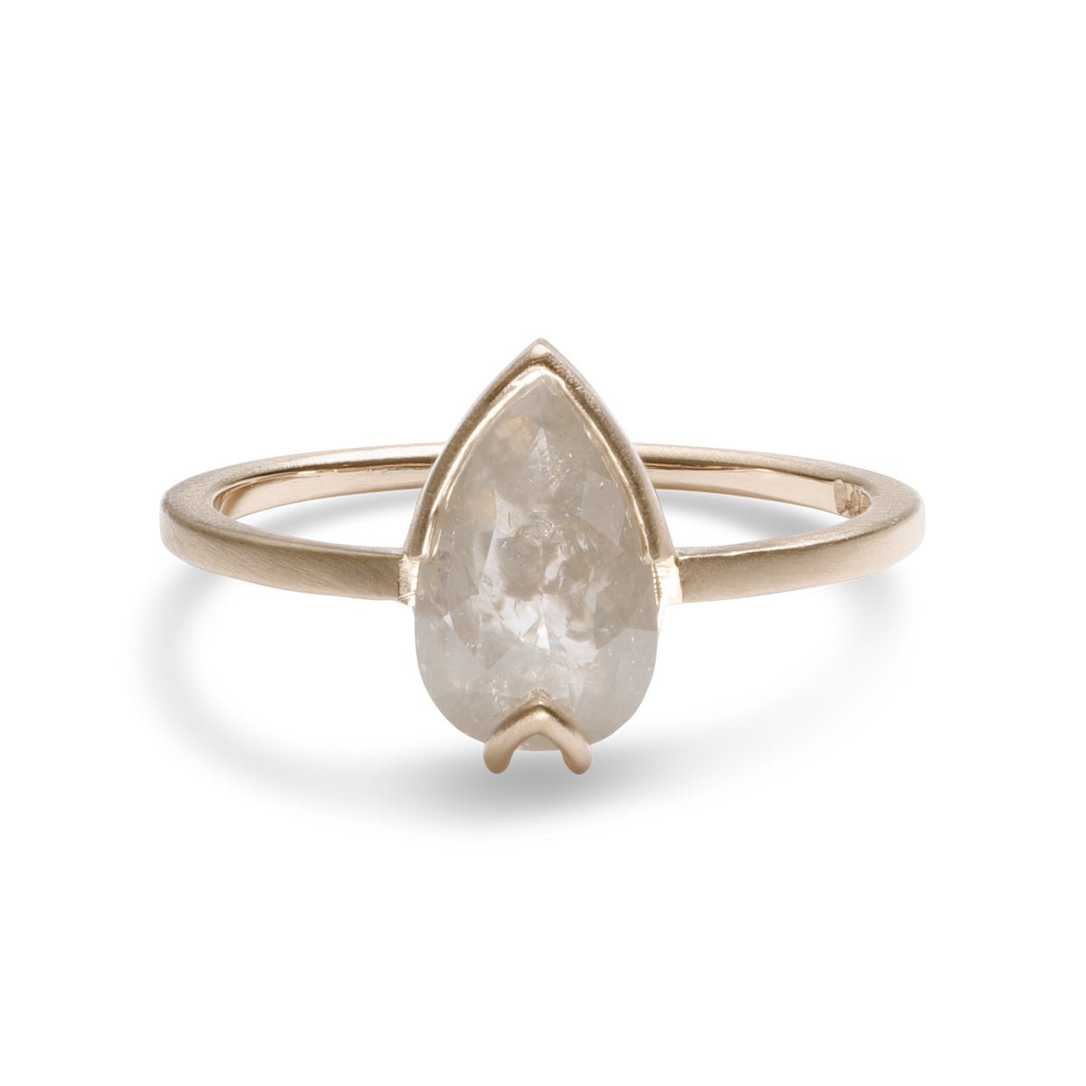 Pear-shaped Ignis ring. Features a salt & pepper diamond set in recycled 14K gold. All stones and materials are conflict free.