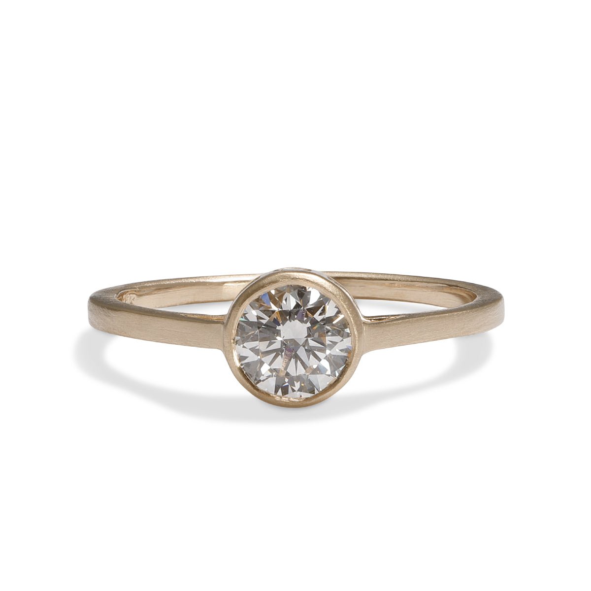 Sano ring from Betsy & Iya in a 14K recycled gold band with two accent diamonds inset on the side and a central round brilliant cut lab-grown diamond (0.6 ct).