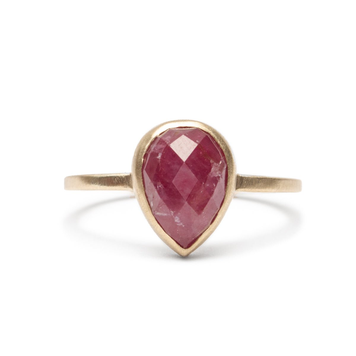 A conflict-free pear-shaped rose cut ruby set in a narrow 14k yellow gold band with a matte finish. The Pirum Ring is designed by Betsy & Iya and handcrafted in Portland, Oregon. 