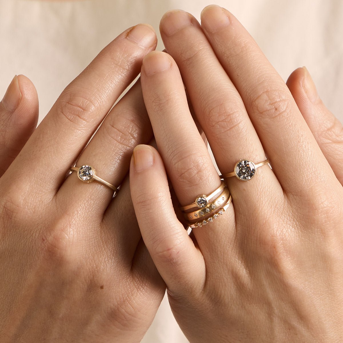 Model wears the Sano rings (from left to right: 0.6 ct, 0.25 ct and 1.4 ct). Model also wears the Aurum and Alma rings.