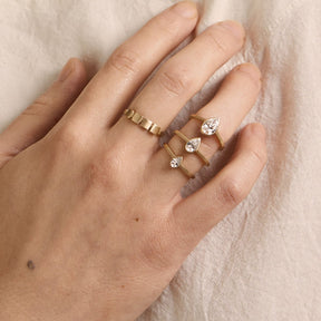 Model wears the Votum rings shown in 0.25 ct, 0.5 ct and 1 ct (from bottom to top) and the Figura ring.
