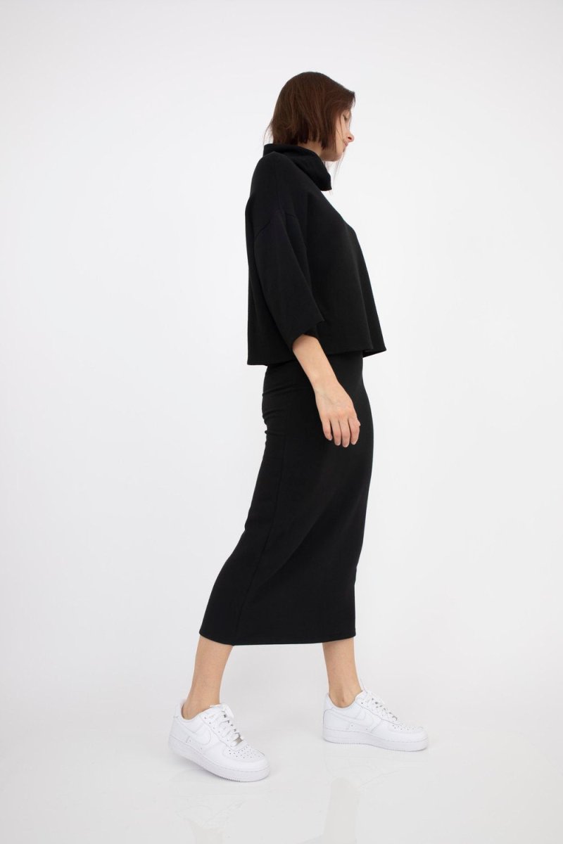 Black high waisted midi skirt with an elastic waistband. The Bailey Skirt in Black is designed by Corinne and made in Los Angeles, CA.