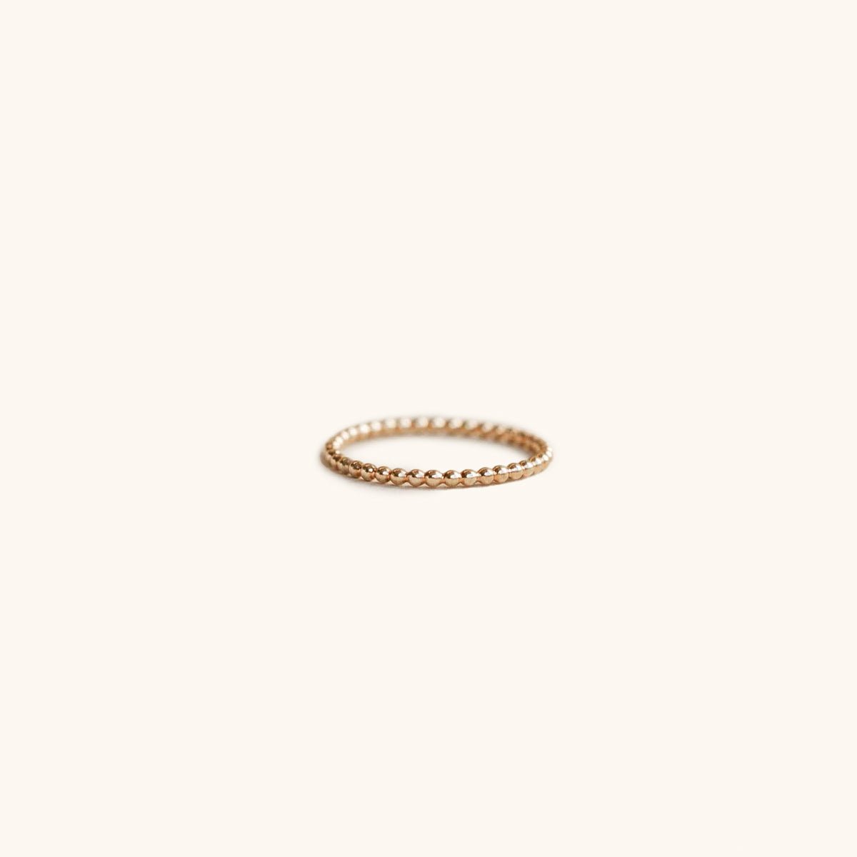 A dainty beaded gold tone ring. The beaded ring is handcrafted by Hello Adorn in Eau Claire, WI.