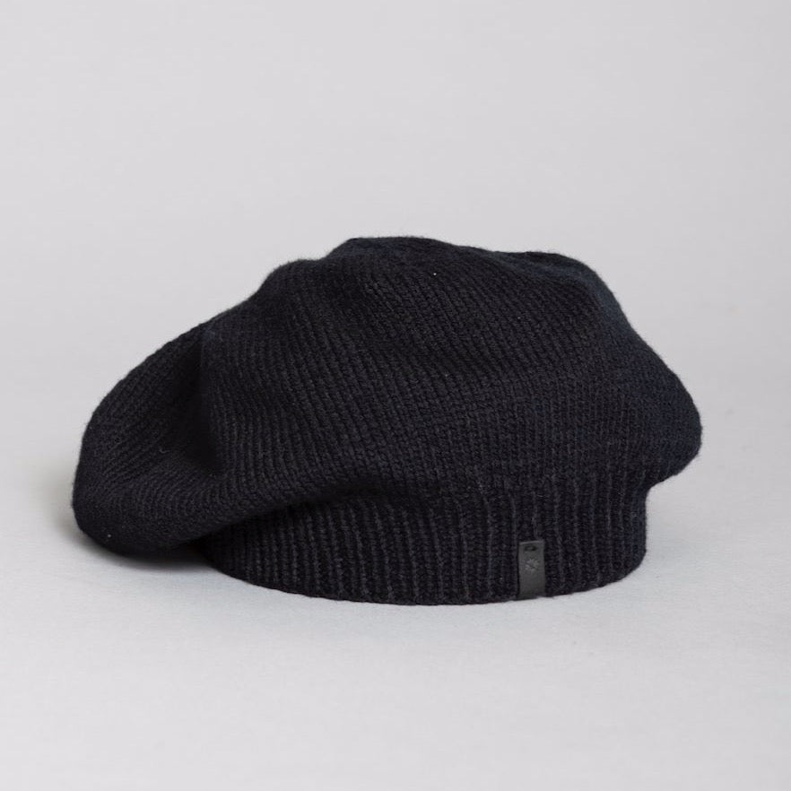 Slouch style hat with a fitted ribbed collar. The Merino Beret in Black is designed by Dinadi and hand knitted in Kathmandu, Nepal.