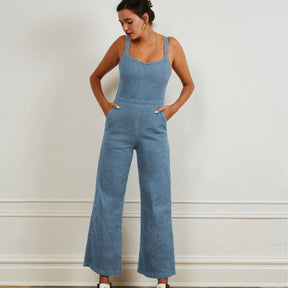 A light blue denim jumpsuit with narrow straps, flared bottom and zipper up the front. The Billy Jumpsuit in Light Indigo is designed by Loup and made in New York City, USA.