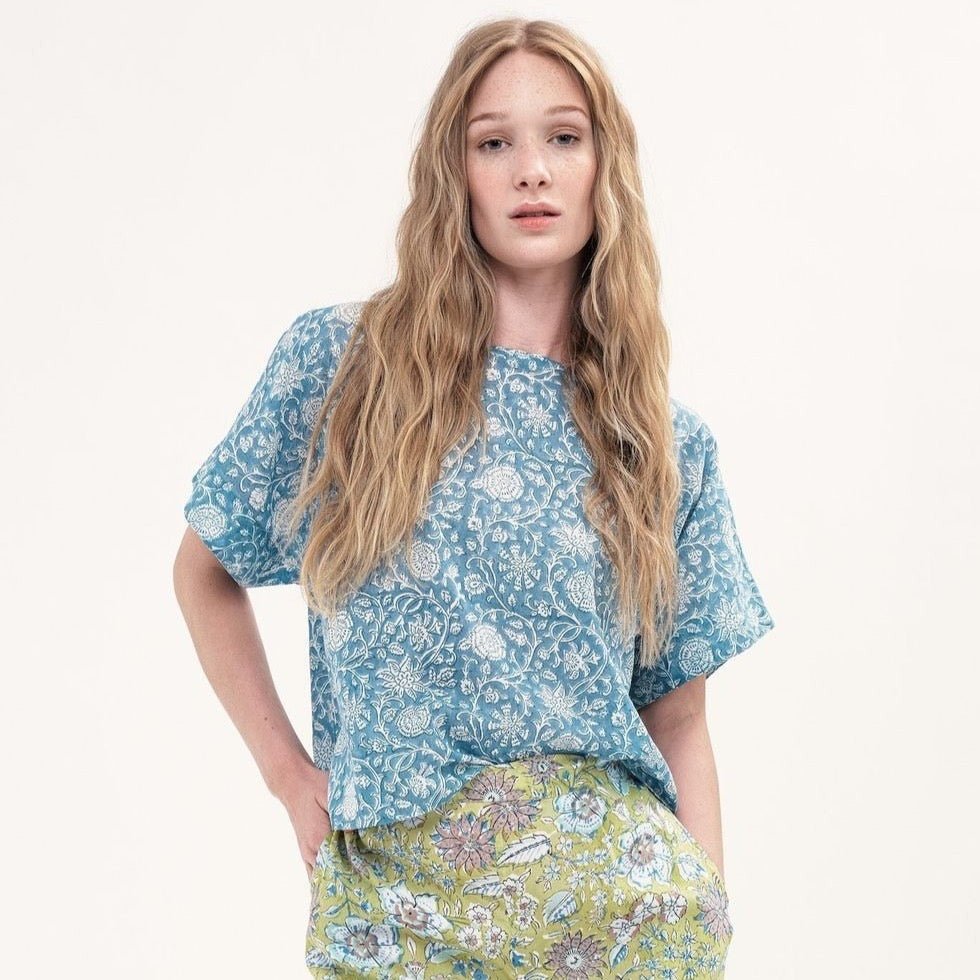 A short sleeve cropped top with a light blue and white floral pattern. The Box Top in Nyla is designed by Maelu and handmade in India.