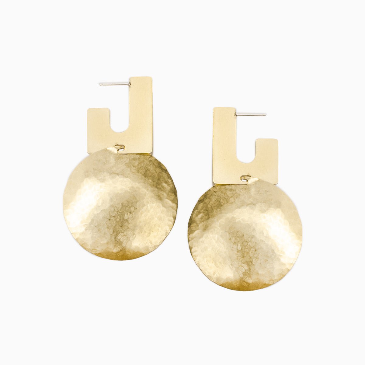 A squared off u-shaped stud earring connected with a large hammered circular disk. The Candetta Earrings are designed and handcrafted in Portland, Oregon.