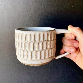 Wheel thrown hand carved mug with speckled glossy white finish. Handmade by Amy A ceramics in Portland, Oregon.