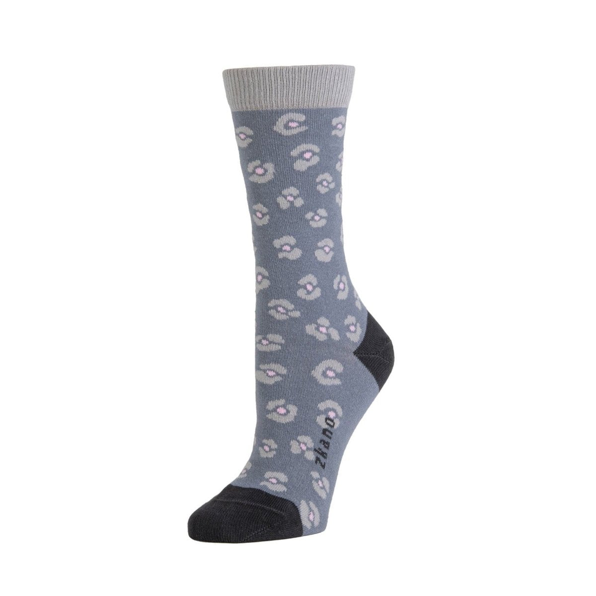 A blue/grey sock with a light blue and pink cheetah pattern. Toe and heel of sock are dark blue, including the logo along the arch. The Cheetah Print Crew in Pewter is from Zkano and made in Alabama, USA.
