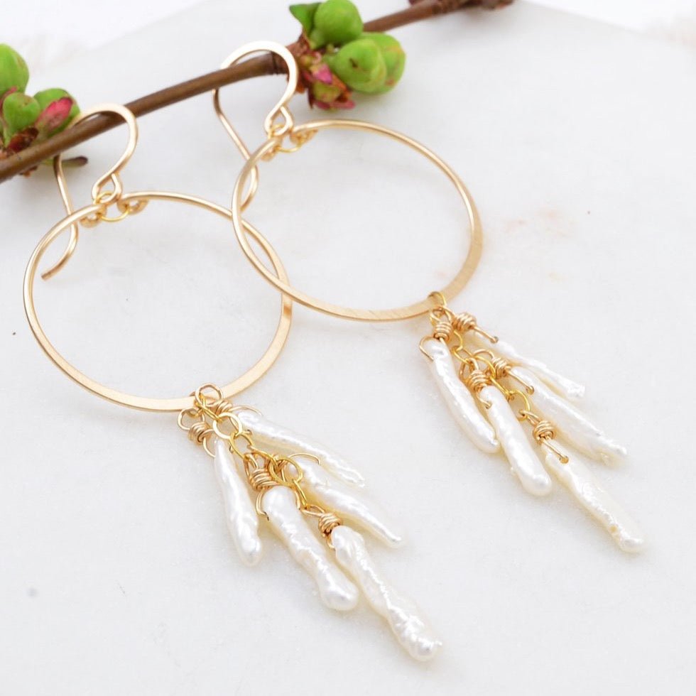 Delicate gold-fill circle earrings with cascading freshwater pearl sticks. The Circle Pearl Waterfall Earrings are designed an handcrafted by Amy Olson in Portland, Oregon.