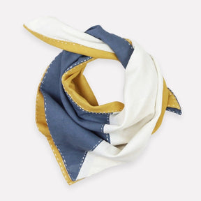 A blue, white and yellow color-blocked bandana with white stitching. The Colorblock Bandana in Asha is designed by Anchal in Louisville, Kentucky and made in Ajmer, India.