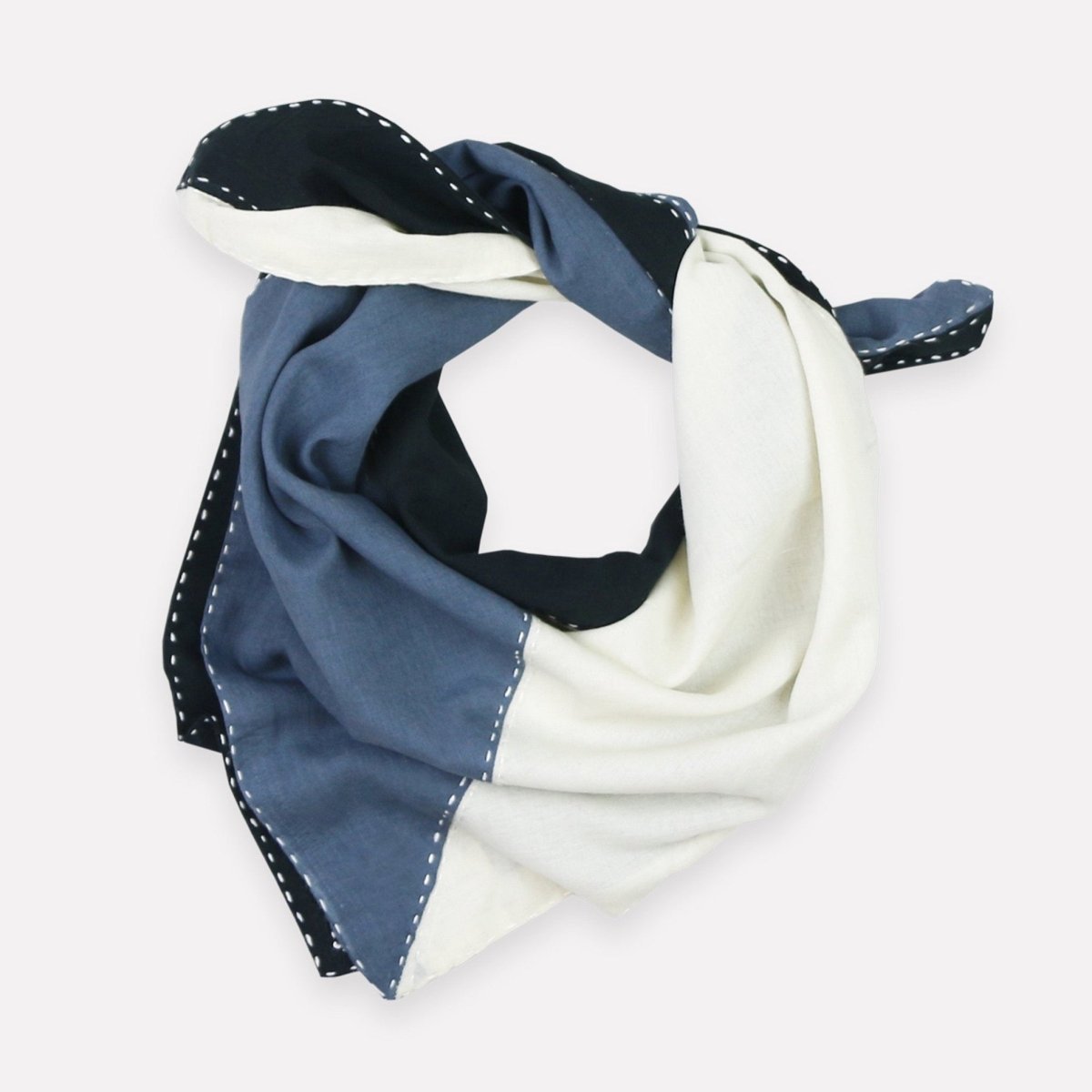 A blue, white and black color-blocked bandana with white stitching. The Colorblock Bandana in Asha is designed by Anchal in Louisville, Kentucky and made in Ajmer, India.