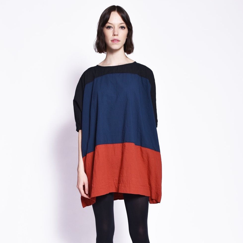 A black, blue and red tunic style dress. The colorblock dress is designed and sewn by Uzi in Brooklyn, New York.